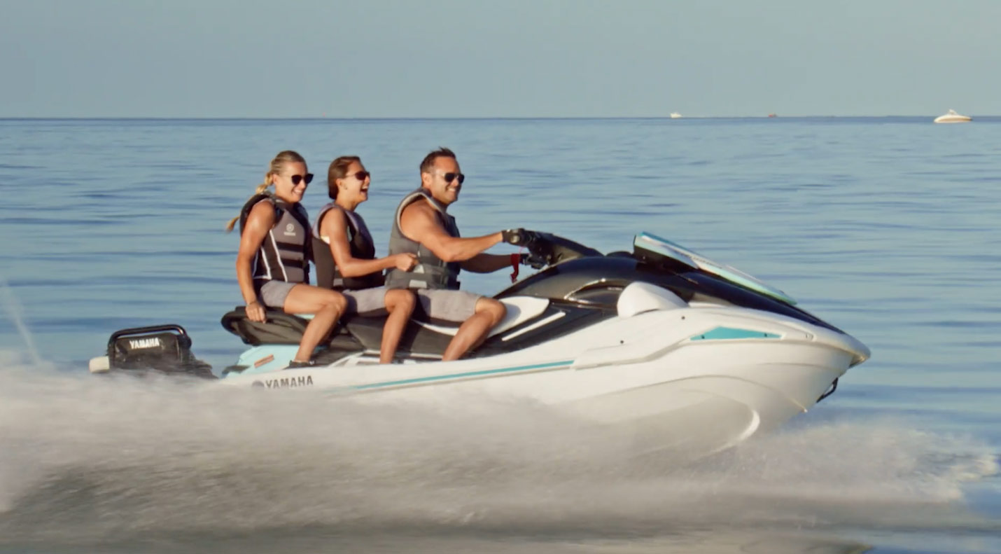 Three people riding on a waverunner